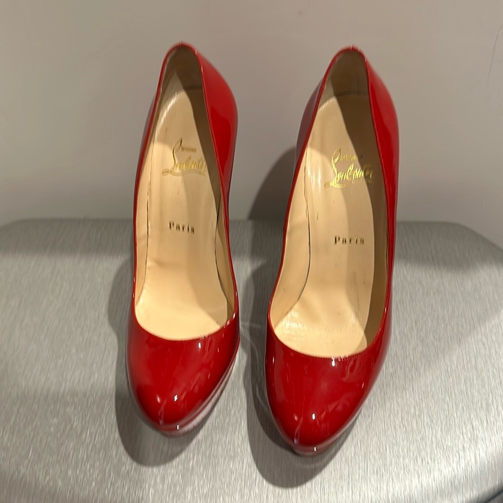 Christian Louboutin red patent leather pumps. With sole protectors.